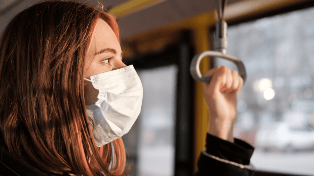 mom on a bus wearing a mask thinking about the pandemic and how covid-19 will effect her divorce