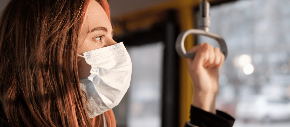 mom on a bus wearing a mask thinking about the pandemic and how covid-19 will effect her divorce