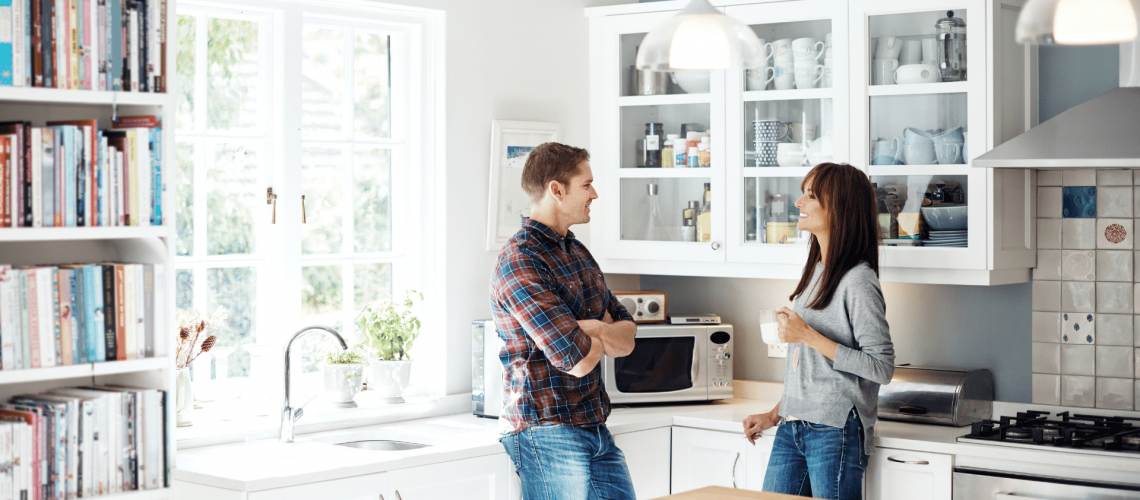 divorced couple talking about the kids schedule peacefully in the kitchen